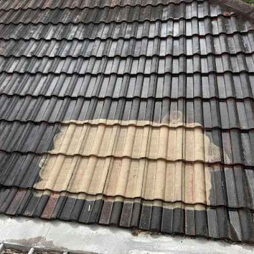 Tiled roof section with a lighter restored patch image from the GTA Roofing website
